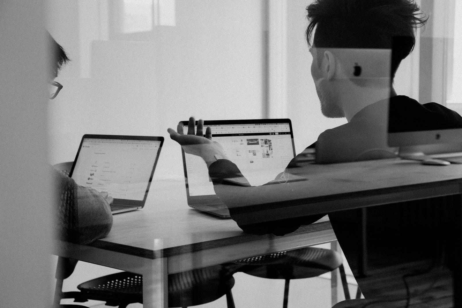 Team reviewing process maps on a laptop